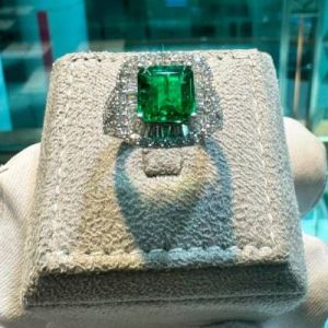 Magnificent Emerald and Diamond Halo Ring in 18K White Gold
